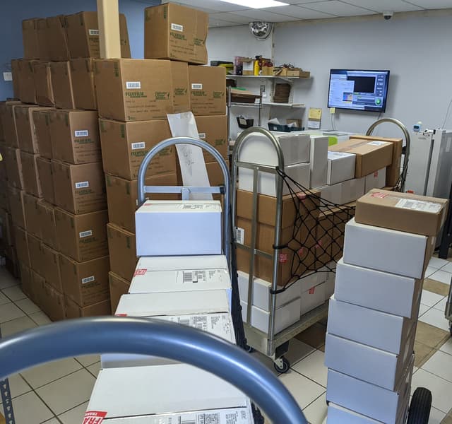 When we're busy we can be really really busy. Boxed up prints in the foreground, fresh fuji paper in the background.